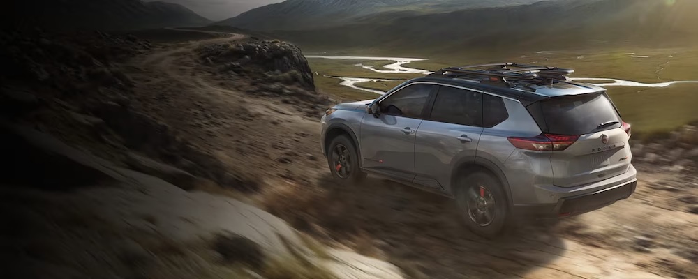 A 2026 Nissan Rogue Rock Creek drives away.